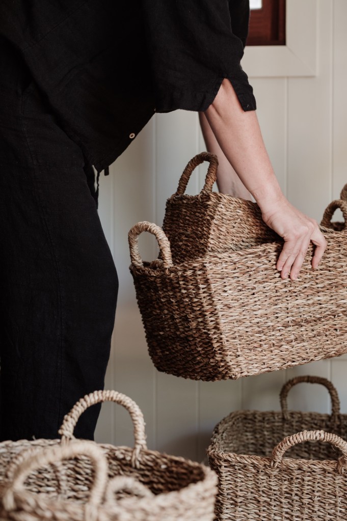 a lady picking up baskets 